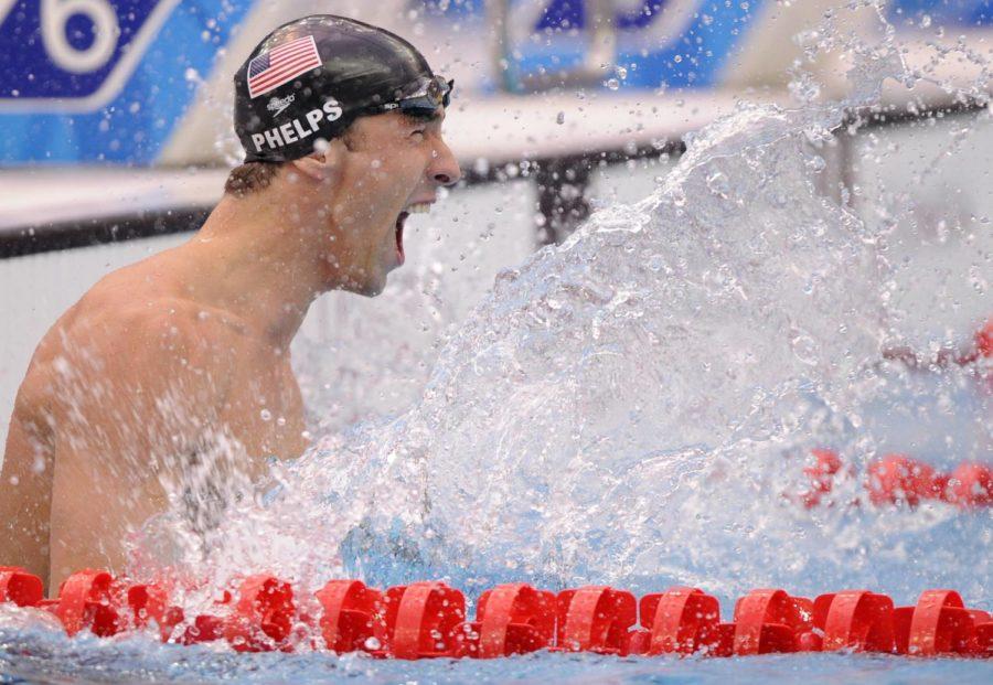 United States' Michael Phelps celebrates winning the gold in the men's 100-meter butterfly final during the swimming competitions in the National Aquatics Center at the Beijing 2008 Olympics in Beijing, Saturday, Aug. 16, 2008. (AP Photo/Mark J. Terrill)