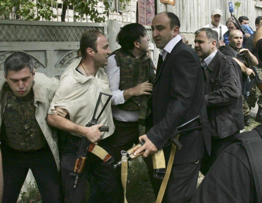 Bodyguards escort Georgian President Mikhail Saakashvili, third from left, wearing a protective vest, to shelter under the threat of Russian air attack in Gori, Georgia, Monday, Aug. 11, 2008. (PHOTO BY THE ASSOCIATED PRESS)