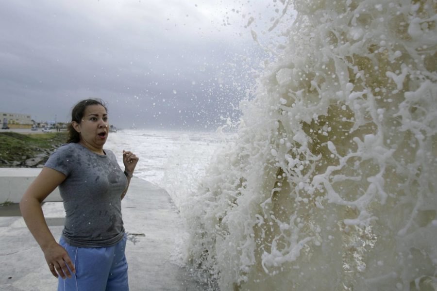 Sylvia Renteria, of Houston, watches a big wave caused by approaching Hurricane Ike crash into the seawall, Friday, Sept. 12, 2008, in Galveston, Texas. Photo: Matt Slocum/Associated Press