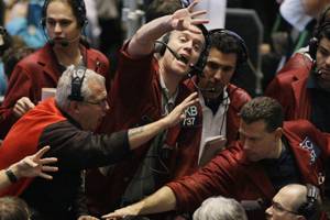 Traders Russel Boose, center, Richard Felman, left, and Michael Carusiello, far right, work in the Eurodollar trading pit Wednesday, Oct. 8, 2008, at the CME Group in Chicago. (AP Photo/M. Spencer Green)