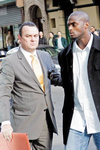 New York Giants' Plaxico Burress, right, arrives at Manhattan Supreme Court for arraignment with an unidentified man on Monday, Dec. 1, 2008 in New York. Burress accidentally shot himself at a Manhattan nightclub Friday evening and was treated at NewYork-Presbyterian Hospital/Weill Cornell Medical Center. He was released Saturday. (AP Photo/David Karp)