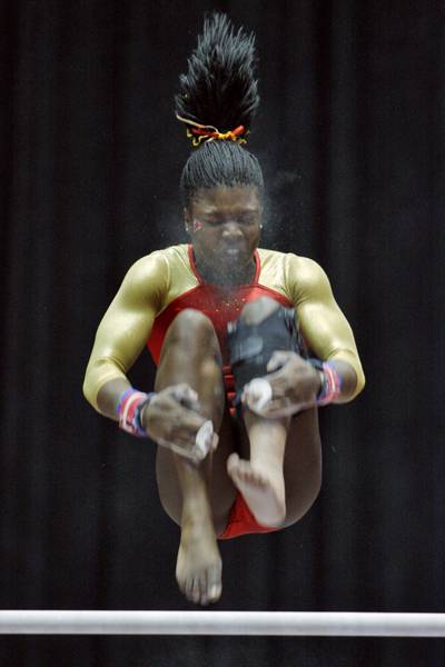 Iowa State sophomore all-around competitor Jacquelyn Holmes dismounts from the uneven bars while competing against the University of Nebraska on Friday at Hilton Coliseum. Iowa State lost to Nebraska 194.775 - 195.550. Photo: Shing Kai Chan/Iowa State Daily