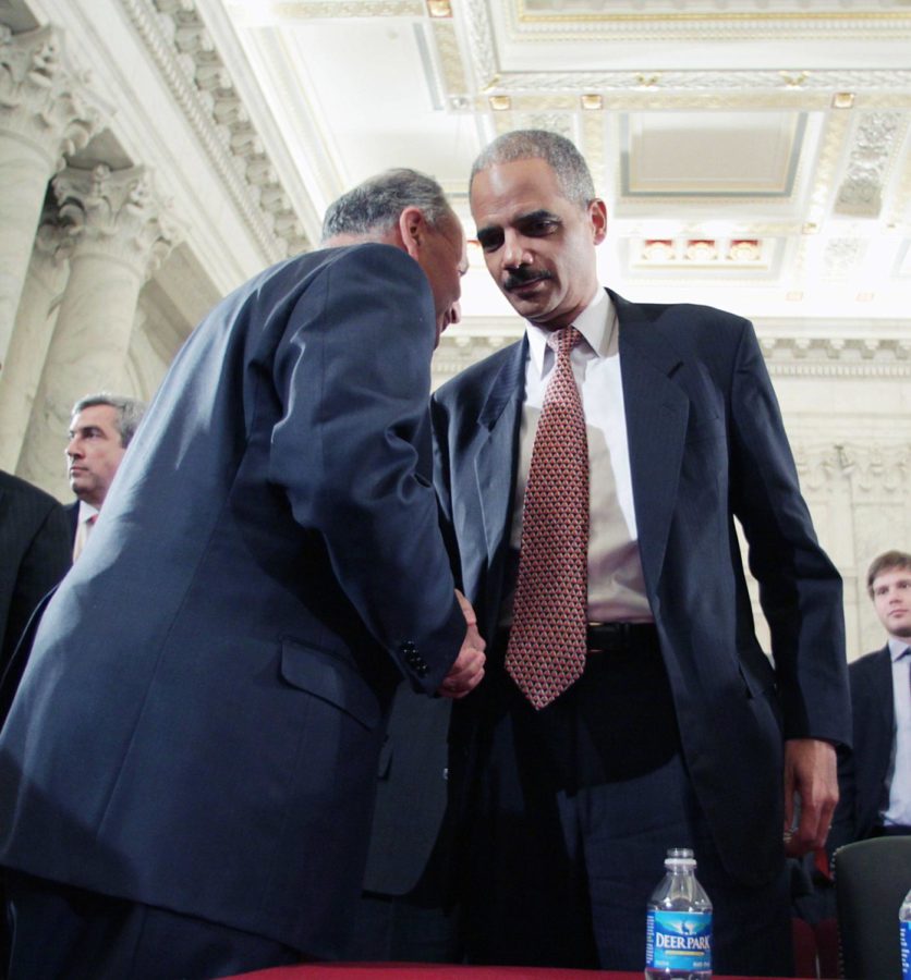 Sen. Chuck Schumer, D-N.Y., left, talks with Attorney General-designate Eric Holder on Capitol Hill in Washington, Thursday, Jan. 15, 2009, during a break in testimony at his confirmation before the Senate Judiciary Committee. (AP Photo/Lauren Victoria Burke)