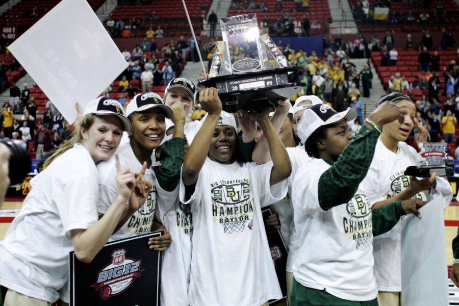 Baylor guard Kelli Griffin holds the championship trophy as the Baylor team celebrates following Baylors 72-63 win over Texas A&M in the championship game at the Big 12 Conference womens tournament in Oklahoma City on Sunday. (AP Photo/Sue Ogrocki)