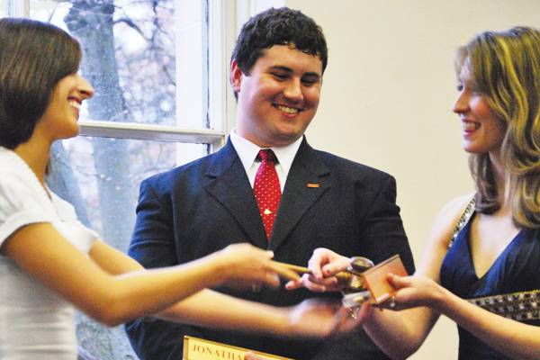 Maggie Luttrell, former vice president of GSB, presents the newly sworn in President and Vice President Jonathan Turk and Chandra Peterson. Photo: Christine Naulty/Iowa State Daily