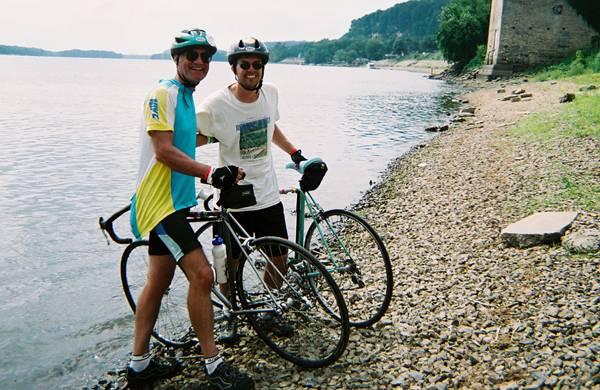 Greenlee School prof Eric Abbott, left, and his son, ISU molecular biology PhD Matt Abbott, celebrate the completion of a RAGBRAI ride by dipping their tires in the Mississippi.