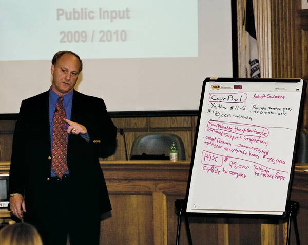 Steve Schainker, City Manager, stands next to a list of budget proposals during a town hall budget meeting. Ames citizens were encouraged to offer budget proposals. Tuesday, October 7, 2008, at Ames City Hall. Photo: Jake Dickey/Iowa State Daily