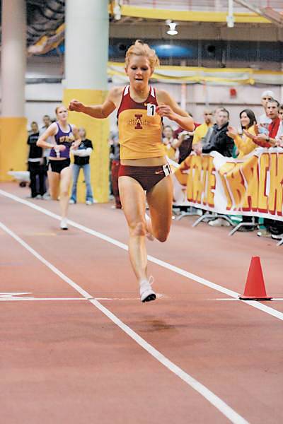 ISU runner Lisa Koll crosses the finish line after setting an ISU school record in the 3,000-meter run at the ISU Open on Jan. 24, 2009. File photo: Iowa State Daily