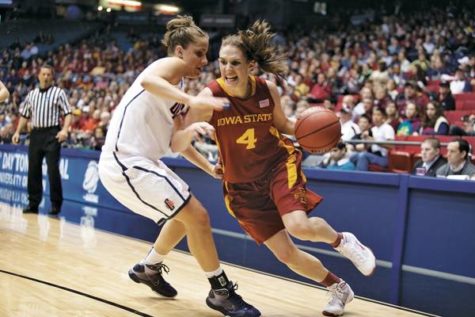 ISU point guard Allison Lacey pushes past a member of the UConn Huskies during the Dayton Regional semifinals Sunday in the University of Dayton Arena in Dayton, Ohio. The Cyclones lost to the Huskies 74-36 to be eliminated from the NCAA Tournament. Photo: Rashah McChesney/Iowa State Daily