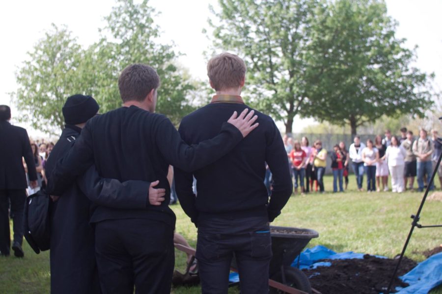 Jon Lacinas mother, father and brother look as friends of Jon attend a memorial ceremony during which a red oak tree was planted, Thursday at the Kings Pavilion behind the College of Design. Photo: Karuna Ang/Iowa State Daily