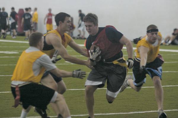 Junior Michael Kirkus returning a punt and attempting to run through some ‘tackles’ at the Veishea Flag Football Tournament on Tuesday night. Kirkus’ team lost 22-14.. Photo: Chris Cuellar/Iowa State Daily