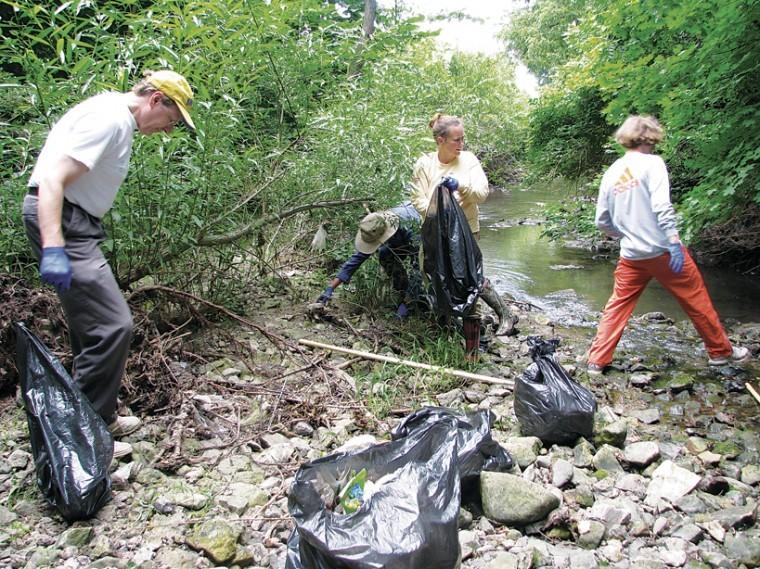 Volunteers clean up a portion of College Creek during the last clean up program. Courtesy photo: Merry Rankin