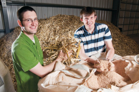 Jared Brown, left, and AJ Pollard, both co-founders and engineers with Avello Bioenergy, are half of the team working toward new applications for biomass. The group is currently working at the Biocentury Research Farm, processing corn silver and wood chips into bio oil, which can then be used as a renewable fuel.