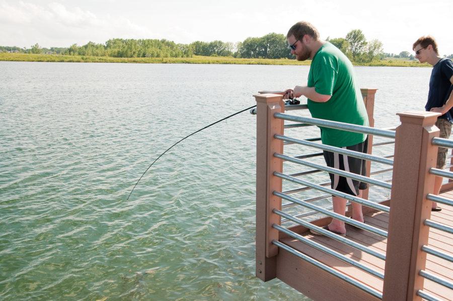 Matthew Crowe, of Ames, fishes for carp on Wednesday at Ada Hayden. The new pier will be dedicated on Saturday at 11:30am.