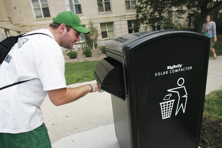 Matt OBrien, senior in accounting and finance, inspects the Big Belly Solar Compactor in front of Curtis Hall on Thursday, August 20, 2009.