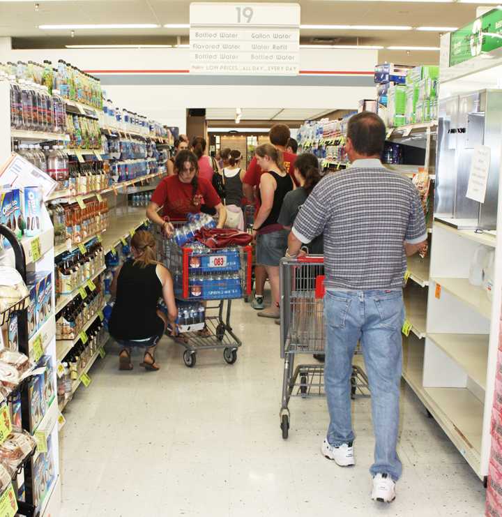 Customers at the west Ames Hy-Vee hurry to get water after the water plant was shut down in Ames on Wednesday, Aug. 11, 2010. The water plant closed due to the flooding in Ames. 