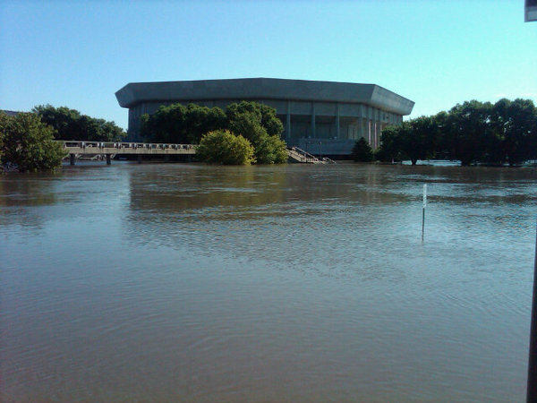 Floodwaters rise between Hilton Coliseum and Stephens Auditorium. Water inside Hilton has forced the ISU volleyball team to relocate practice and reschedule all home games to be played at Ames High School.