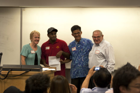 Jean Kresse, left, Ashvin Sudhaharan, Choy Leow, and Dr. Riad Mahayni stand with the check from the Malaysian Alumni on Saturday, Aug. 28. The Malaysian Alumni donated $1,000 to Ames for flood relief.