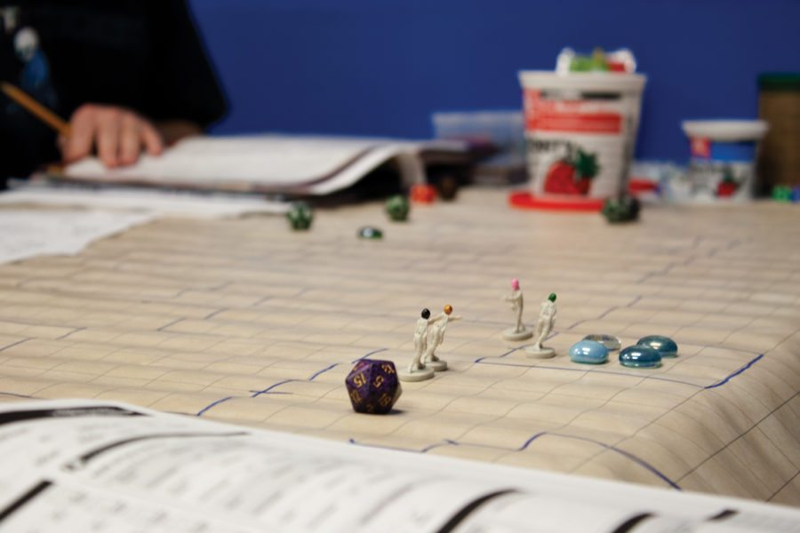 Dungeons and Dragons game pieces sit during an active game at Mayhem comics. Mayhem Collectibles is open on Lincoln Way from 10 a.m. to 8 p.m. Monday through Saturday and 10 a.m. to 7 p.m. on Sundays.