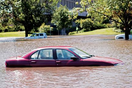Cars sit in the flood waters in the MWL parking lot on Wednesday, Aug. 11.  