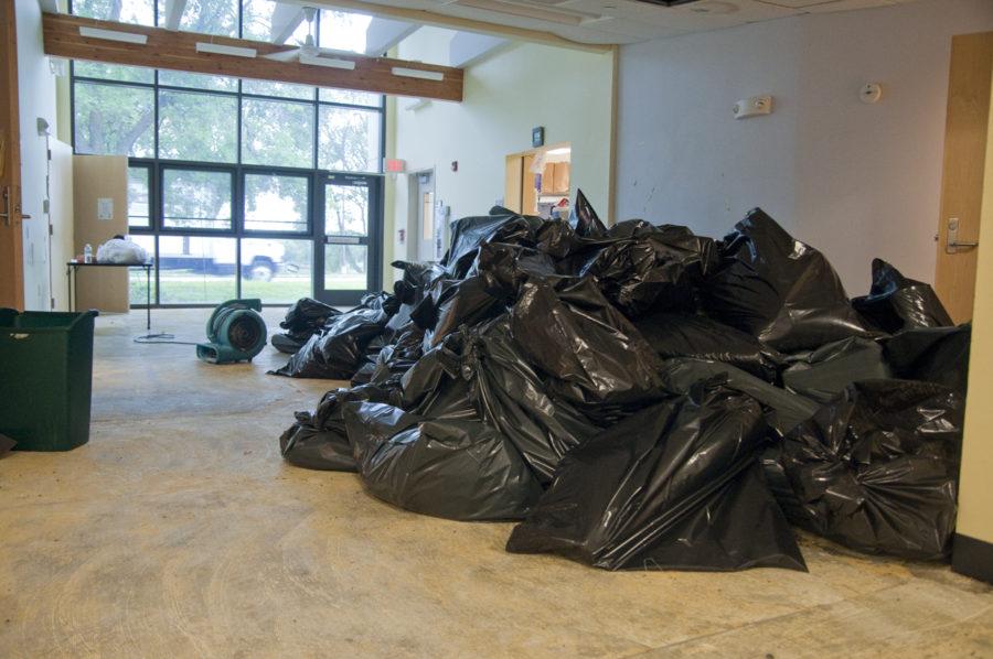 Piles of trash bags, filled with the water-damaged carpet sit in a hallway of the University Community Childcare building on Friday, Aug. 13, 2010.