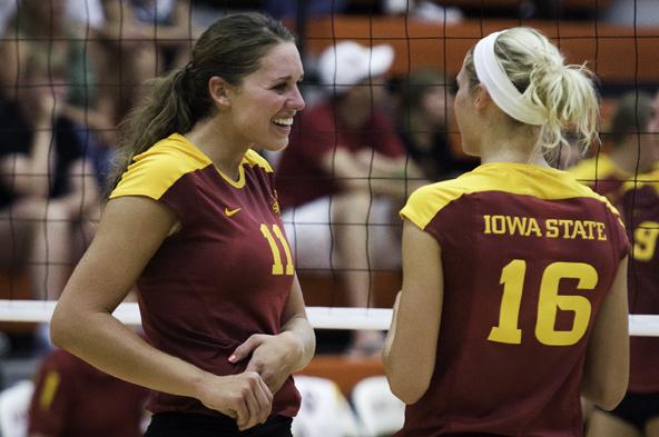 Taylor Knuth, left, middle blocker and right side hitter, talks with Hannah Willms, outside hitter, before the Cyclones annual Cardinal-Gold scrimmage starts on Aug. 21 at Ames High.