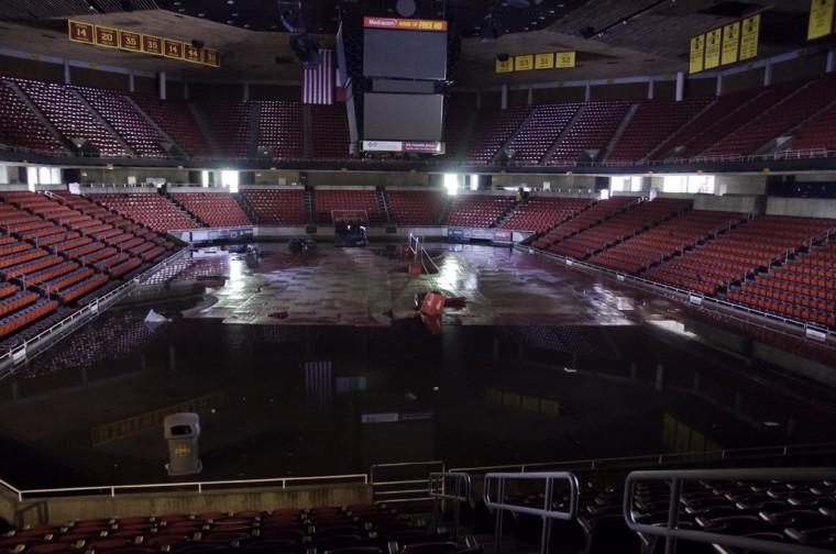 The wooden court in Hilton Coliseum floats on the surface of approximately 10 feet of floodwaters Thursday. Crews are pumping water out of the building and are still unable to access some of the lower areas such the locker rooms.