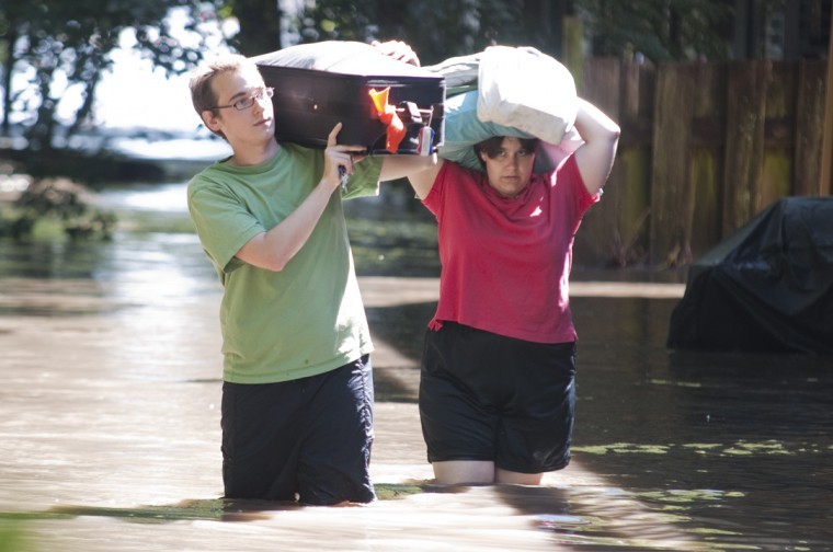 Sean Riley, left, and Heather Caruthers, both graduate students in chemistry, remove some possessions from their apartment after flooding on Wednesday, Aug. 11, 2010, at Southview Estates. Ames Residents near South Duff Avenue were being evacuated beginning as early as 11 p.m. Tuesday, Aug., 10.