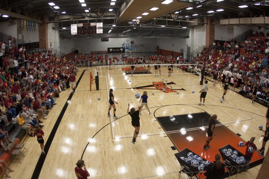 The+UNI+volleyball+players+warm+up+in+the+Ames+high+school+gym+right+before+the+start+of+the+ISU-UNI+game.+Due+to+the+flooding+of+Hilton+Coliseum%2C+Ames+high+gymnasium+is+now+being+used+as+the+home+turf+for+the+Iowa+State+volleyball+team.