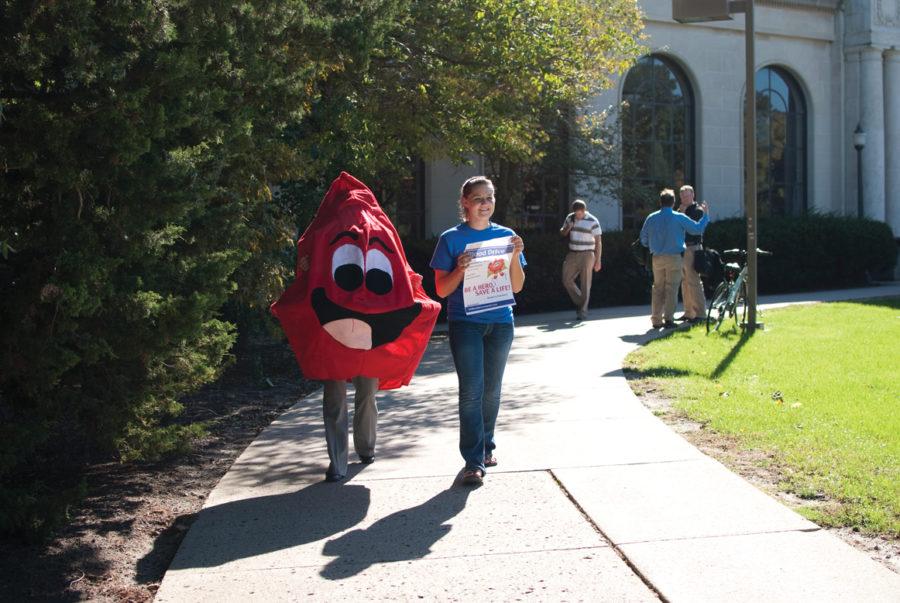 Abby Long, right, senior in genetics and recruitment executive for blood drive, and Chelsea Anderson, junior in accounting and volunteer executive for blood drive, go about campus and tell students about the blood drive that is going on at the Great Hall, Tuesday, Sept. 28, outside of Memorial Union. 