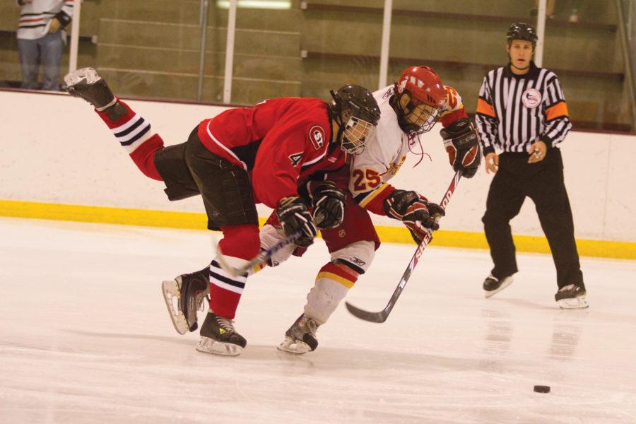Defenseman Matt Bennett fights to keep the puck from his opponent during Fridays game against St. Cloud. The Cyclones defeated the Huskies 6-0 at the Ice Arena.