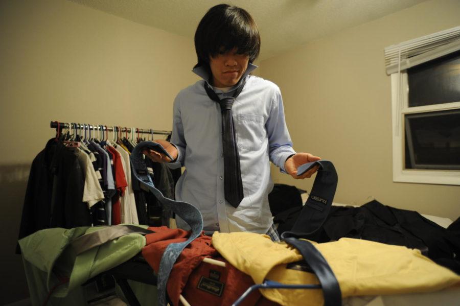 Byoungwoo Choi, sophomore in pre-business, decides what to wear for the career fair. Choi sees the career fair as an opportunity for him to look at what the real world has to offer him and is also the first step in seeking a career. 