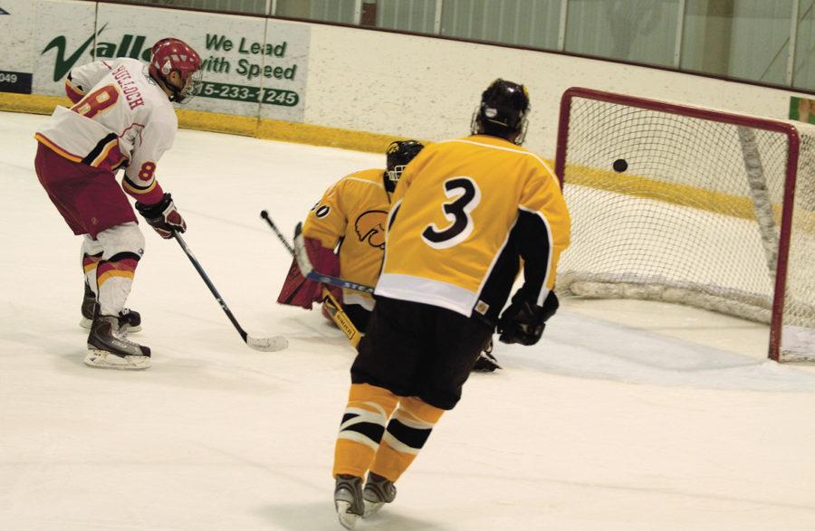 Cort Bulloch, junior forward, shoots at the goal during the 2009 game against Iowa at the Ames/ISU Ice Arena.