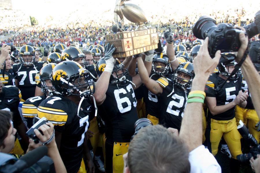 The Hawkeyes celebrate with the Cy-Hawk trophy after winning the Iowa-Iowa State game on Saturday at Kinnick Stadium. The Hawkeyes won with a score of 35-7. 