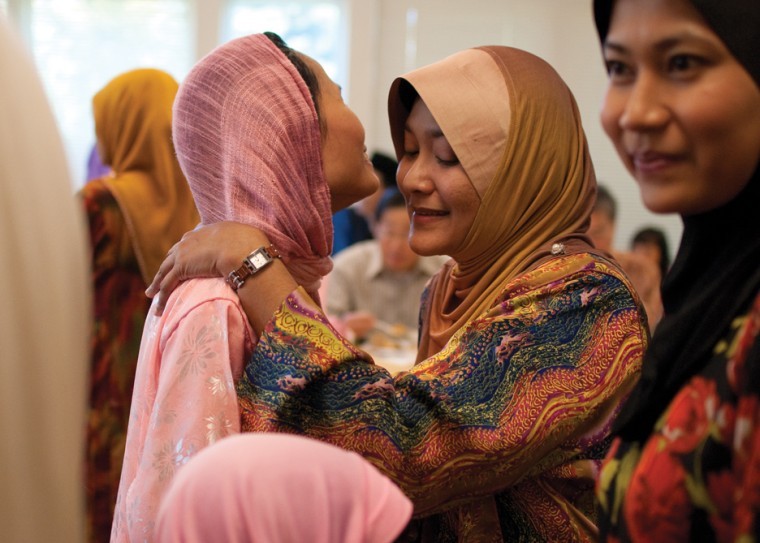 Siti Sabtu-Schaper, ISU administrative specialist, greets Siti Noridah Ali, graduate in curriculum and instruction, during the Eid ul-Fitr celebration Saturday, Sept. 11 at SUV Community Center. There are different ways for Malay to greet each other. Traditionally, men and women usually do not shake hands with each other. A Malay man greets another man with a light handshake using their right hand thats more like a light clasp. They will then bring their hands towards the heart, meaning, I greet you from my heart. 