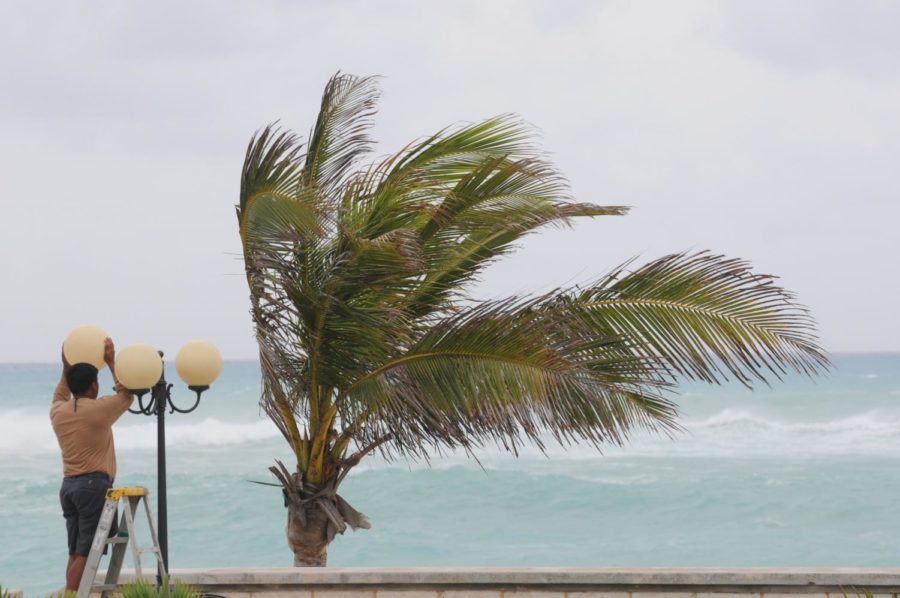 George Venoza, a worker at the Elbow Beach Hotel in Bermuda, removes a light globe Saturday in preparation for the arrival of Hurricane Igor, which is expected to hit the island on Sunday and Monday.
