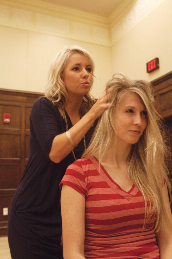 Krista Harvey, from Studio 7 Salon, puts volumizing powder in Chandra Petersons hair, senior in political science, during the Ladies Expo on Tuesday in the Great Hall of the Memorial Union. A variety of businesses, like Studio 7 Salon, were on hand for the expo.