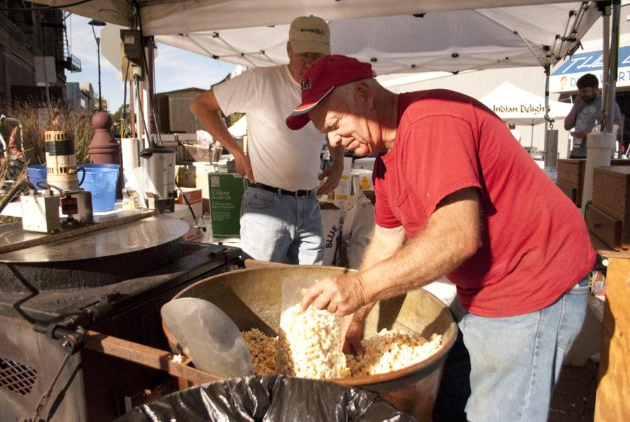 Virgil Niehaus of Sauk Center, Minn. makes a bag of popcorn at Ottes Old Fashion Kettle Korn during the 40th Annual Octagon Art Festival on Sunday, Sept. 26, 2010 on Main Street.