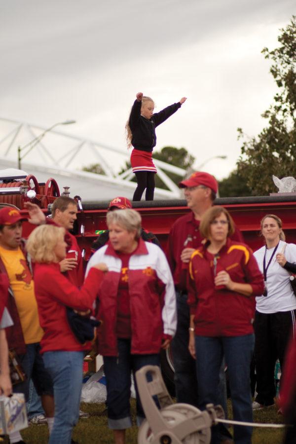 A young girl dances on top of a fire truck while the ISU marching band plays before the start of the game Thursday, Sept. 2.