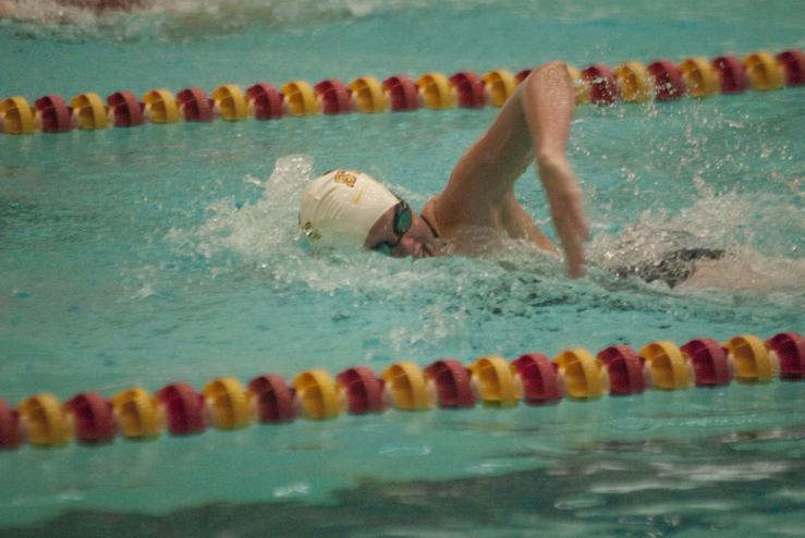 Freshman Alex Gustafson competes in the 100-yard freestyle during the intrasquad swimming meet Friday. Gustafson competed as part of the Gold team, which defeated the Cardinal team by a score of 131-93.