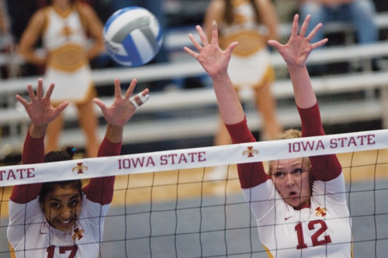 Middle blocker and right-side hitter Tenisha Matlock, along with middle blocker Debbie Stadick, reach up for a block during Saturdays game against Kansas. Matlock helped the Cyclones with two digs and two kills.