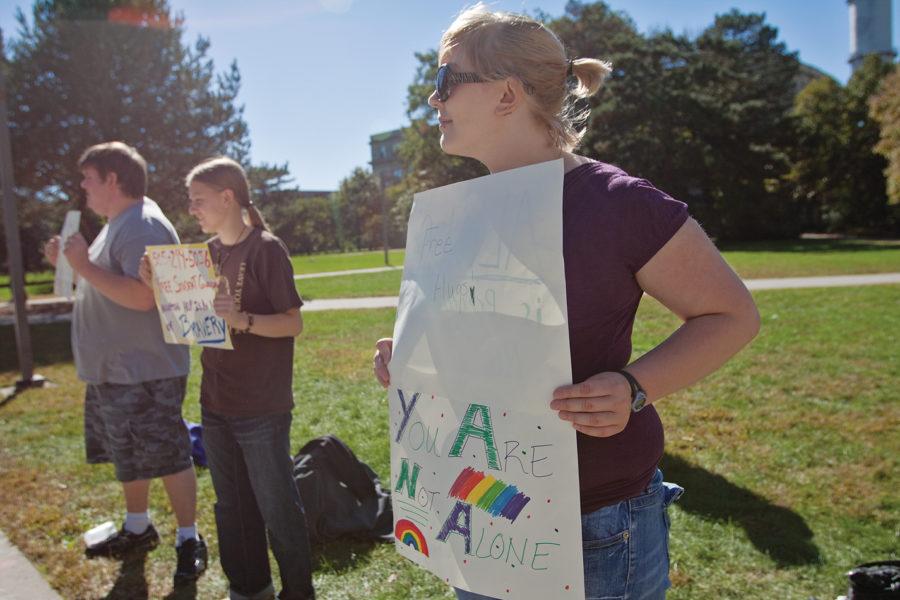 Ruth Hines, freshman in psychology, Ariel Jetty, sophomore in animal ecology, and Michael Odland, freshman in political science, participate in Vigil for the Lost Lives of 5 LGBTQ on Monday, Oct. 4 in front of Parks Library.