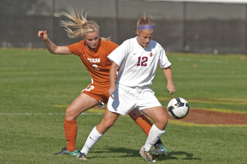 Forward Amanda Cacciatore dribbles the ball away from Texas defender Nina Frausing Pedersen during Sundays match at the ISU Soccer Complex. Cacciatore had three shots attempted at the Longhorns goal in the Cyclones 2-1 loss.