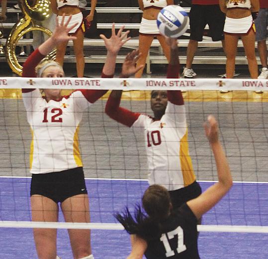 Outside hitter Victoria Henson and middle blocker Debbie Stadick jump up for a block during the Wednesday, Oct. 13 game against Kansas State at Ames High School. The Cyclones take on Kansas on Saturday, trying to avenge their loss to the Jayhawks on Oct. 9.