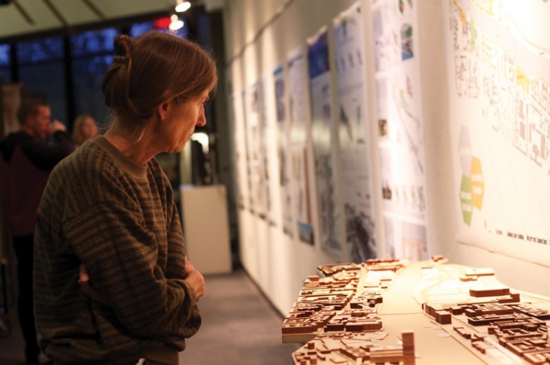 Catherine Scott, citizen of Ames, looks at a model of instruction during Toward Sustainable Cities exhibition on Oct. 25 at the College of Design.  
