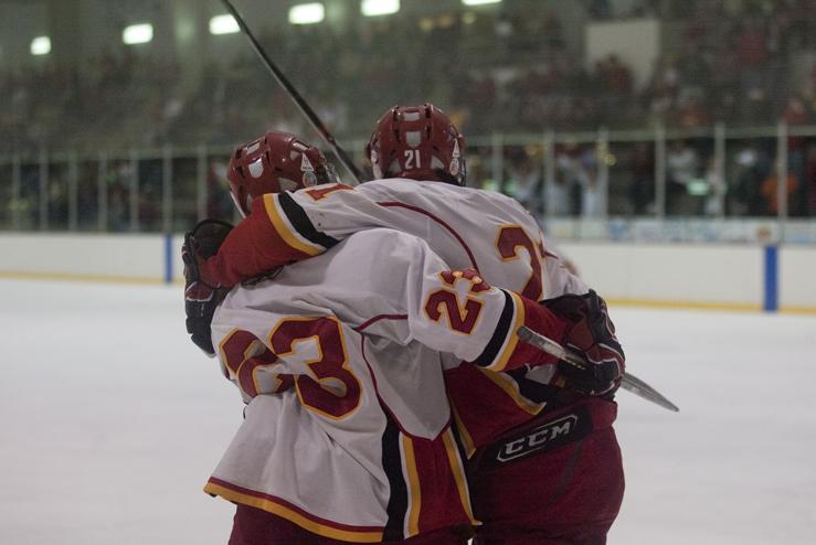 Freshman Chris Cucullu and Senior Mike Lebler celebrate after a making a goal during the third period. After entering the period with the Davenport Panthers in the lead, the Cyclones scored three goals and won with a score of 5-3.