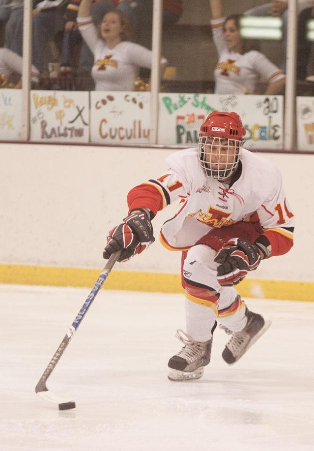 Iowa States Jake Flynn maneuvers the puck Friday, Oct. 1, at the Ames/ISU Ice Arena.