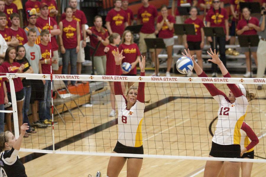 Right side hitter Kelsey Petersen and middle blocker Debbie Stadick go up for a block against the UNI volleyball team during the game at Ames high on Wednesday night.  Iowa State defeated Northern Iowa winning three games against the Panthers.