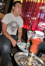 Ben Meyer, senior in liberal studies and president of the ISU Hookah Club, blows smoke Wednesday at the Chicha Shack. The Hookah Club meets every Wednesday at 8 p.m. at the Chicha Shack on Lincoln Way.