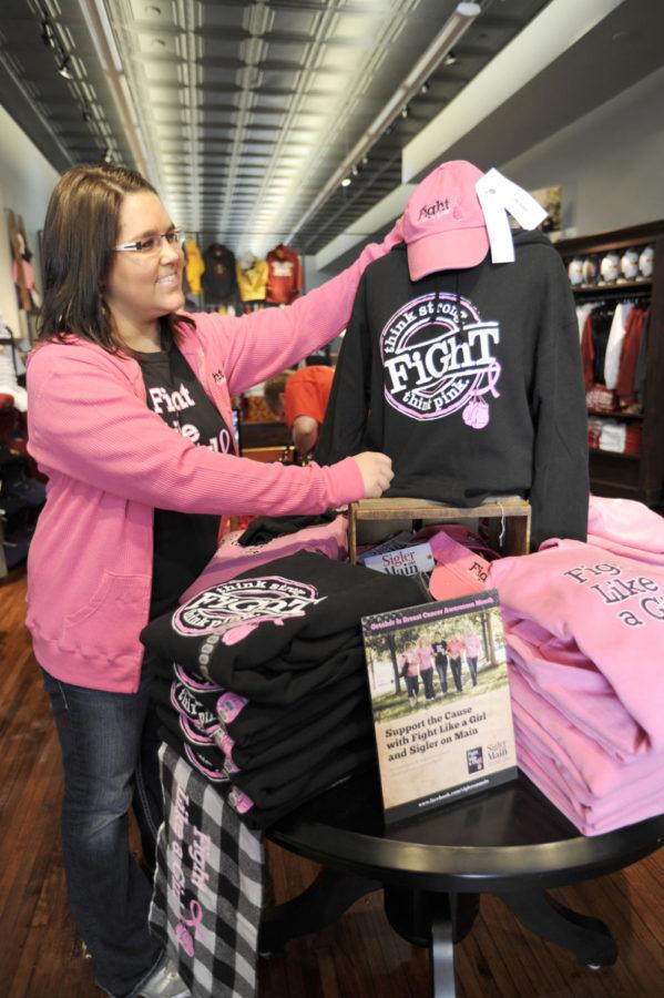 Nikki Kerns, junior in journalism, sells Fight Like a Girl T-shirts at Sigler On Main on Saturday, Oct. 16. Kerns thinks its a really good cause, and she loves working for a company that gives back. Photo: Yue Wu/Iowa State Daily